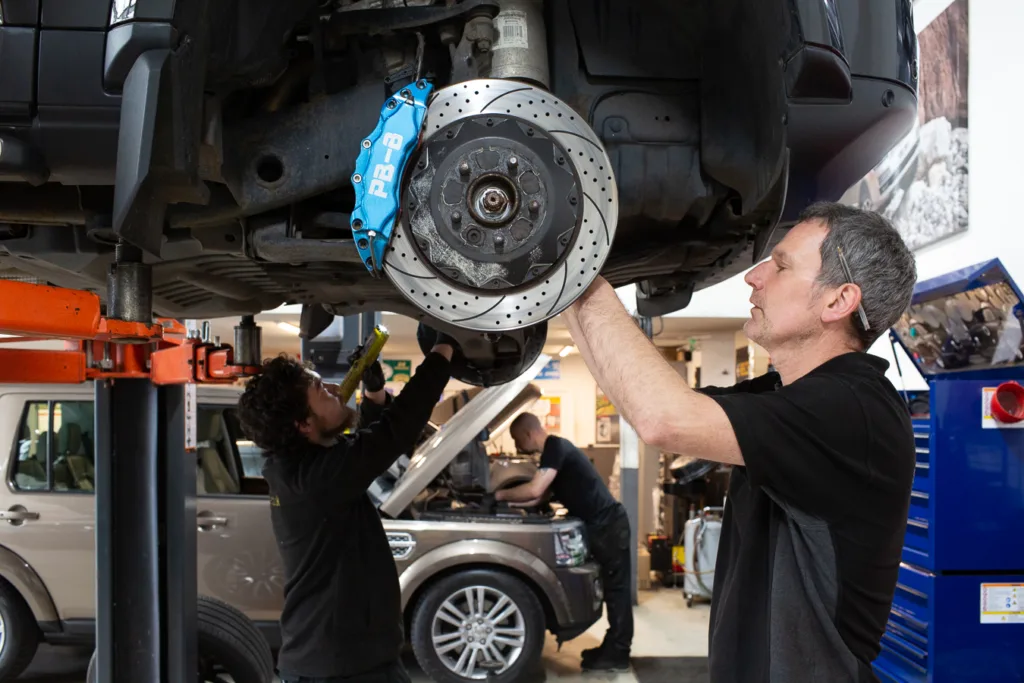 CSG Automotive mechanic working on a set of brakes