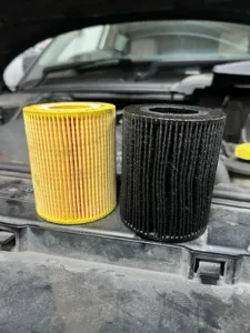 Old oil filter next to a new oil filter.